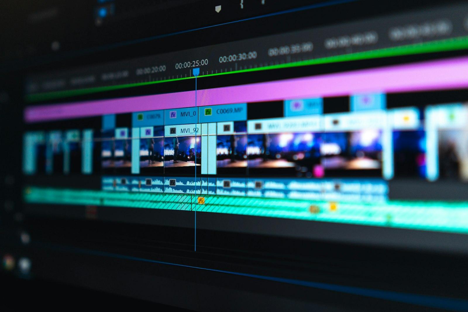 Video editing timeline open on a laptop in a modern workspace